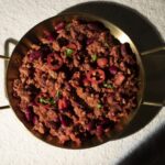 Plant-based chilli con carne with kidney beans and sliced chili in brass serving dish – Amoria Foods